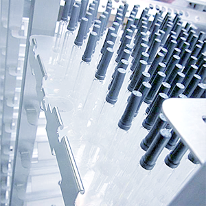 A picture of a sterilization Volcanorack stainless-steel cart loaded with a tray turned upside down with 160 nested syringes securely held in place